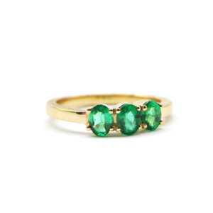 Yellow gold ring with three oval cut emeralds